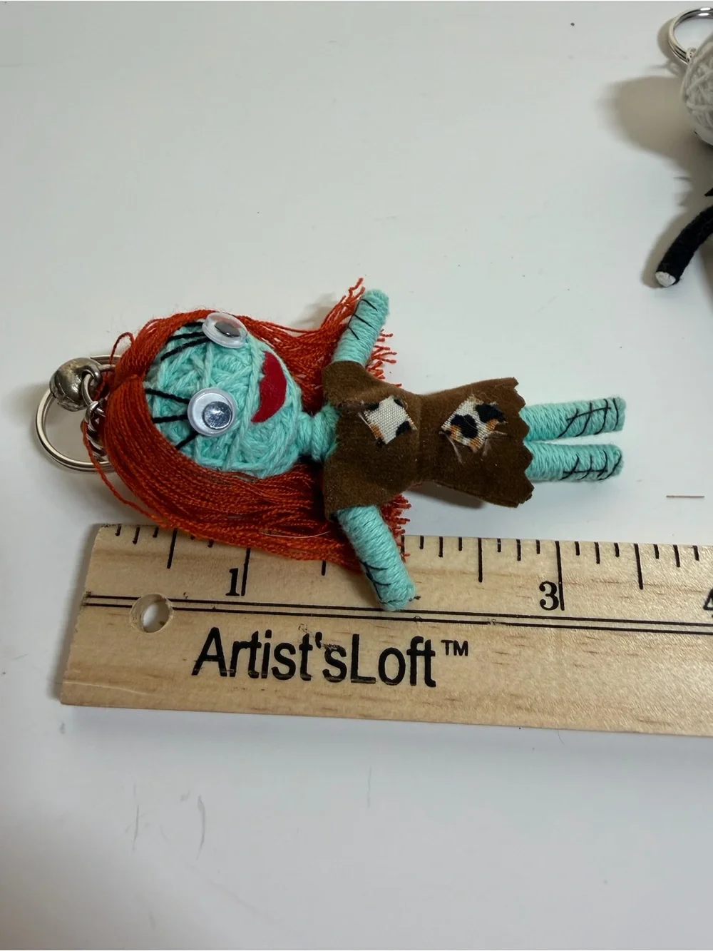 Jack Skellington and Sally string doll keychains. Backpack